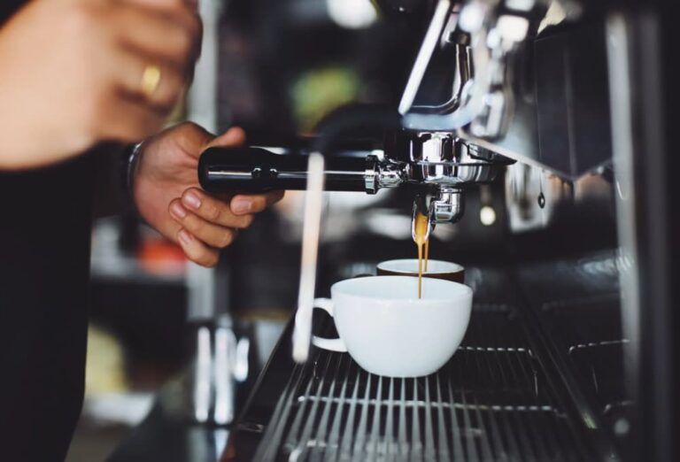 Espresso pouring into a white cup from a machine
