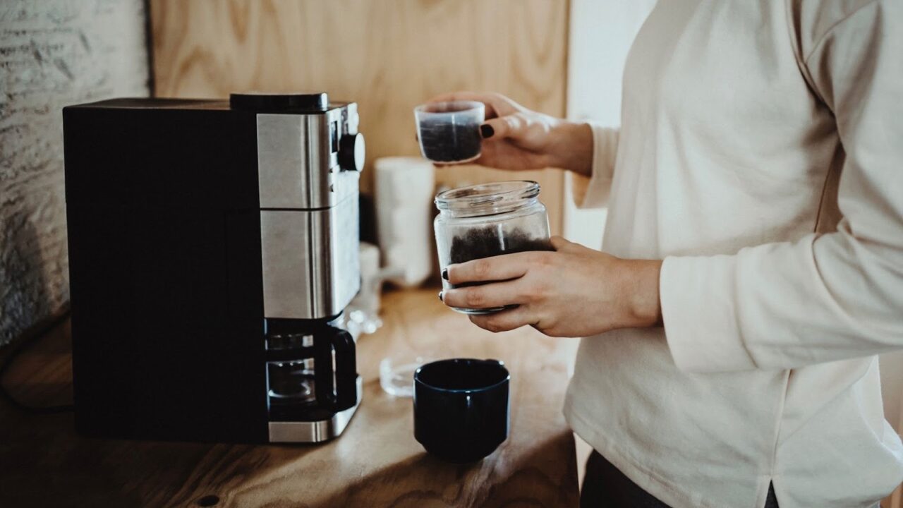 Man making coffee using a coffee machine at home