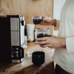 Man making coffee using a coffee machine at home