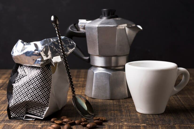 Flat Lay of Coffee Grinder with Sack and Mug